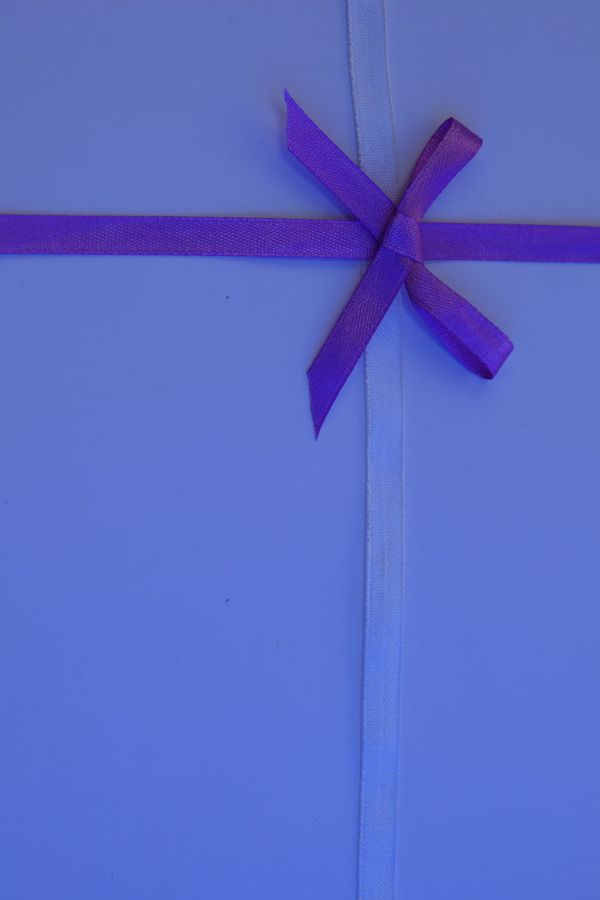 The Comfort Gift Box in purple wrapping with a bow