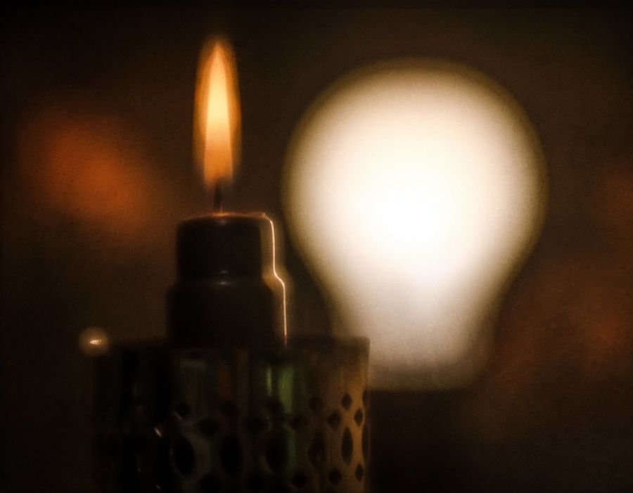 A warm candle glowing softly in a cozy room